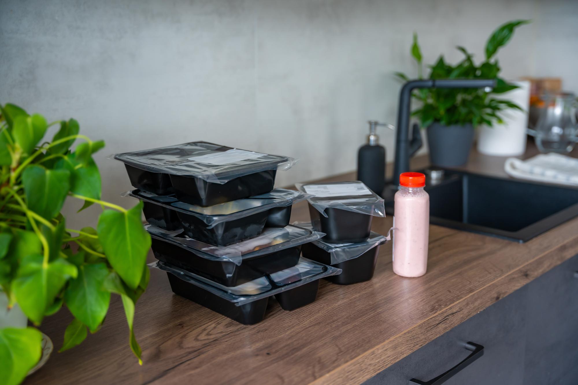 Stack of packaged meal kits ready for pickup